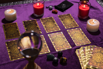 Pack of tarot cards near candles