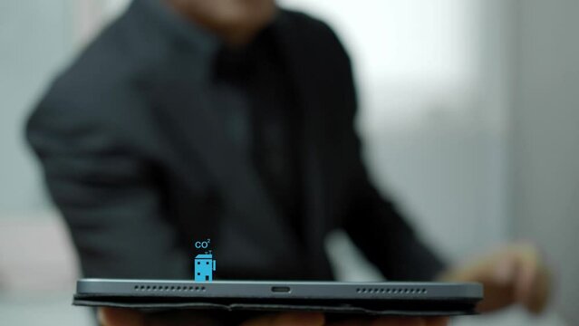 Businessman showing his tablet with virtual tree icons. Net zero greenhouse gas emissions target. Climate neutral long term strategy. Ecological, renewable energy and save environment concept