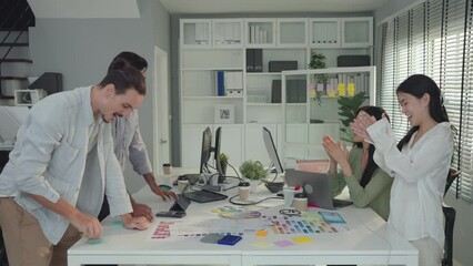 A small business team celebrates project approval, a defining moment of success, Multiracial coworkers celebrate project approval. A startup project gets approval in an office meeting, Sucessful team