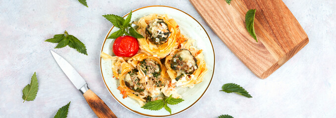 Fettuccine pasta nests and meatballs.