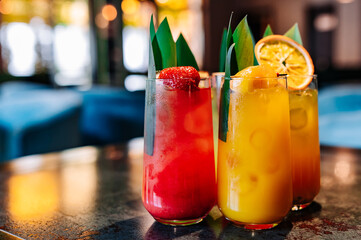 set Glass with tropical juice lemonafe with fruits on table