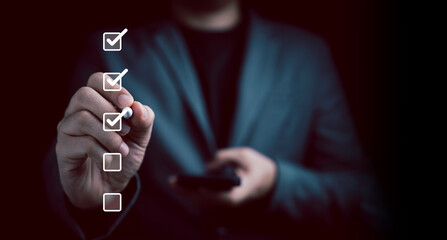 Businessman use pen to tick correct sign mark in checkbox for quality document control checklist...