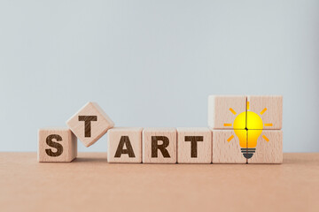 START word on wooden cube block with brighten lightbulb, for restart, start up, reopen, creative,...