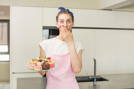 covering mouth with a hand and shocked or surprised expression. home made cakes concept