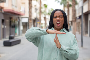 afro pretty black woman looking serious, stern, angry and displeased, making time out sign