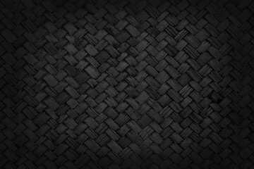 Old black bamboo weave texture background, pattern of woven rattan mat in vintage style.
