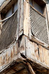 Fototapeta na wymiar Wooden shutters on the bay window of the wooden house