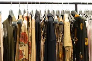 Clothes and dresses in neutral shades on a hanger