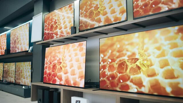 Department Store Electronics Section Showcasing a Range of of Modern Big TVs. Assorted Flat-Screen Televisions Convey Modernity and Technological Advancement with Perfect Quality and 4K Resolutions