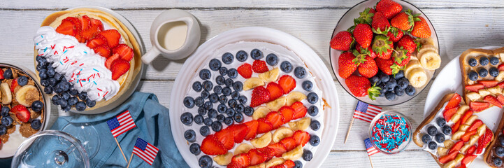 Fourth of July, Patriotic Independence day desserts.  4th of July sweet brunch food and snacks - toast sandwiches, flakes with berries, cake, pancakes, champagne with glasses, holiday decor, flags 