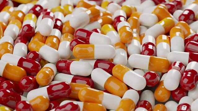 Many red orange white capsule pills spin around. View from the side 3D render animation