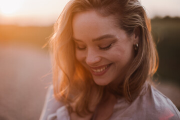 Portrait of beautiful woman outdoor during sunset.