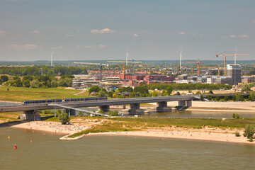 Aerial view of the Waal river with beach and construction of new houses and offices in Nijmegen and Lent, The Netherlands