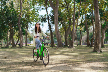 Women riding bicycle with enjoying for relaxation and exercise with healthy lifestyle in the park