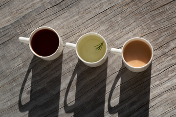 Hot tea in three mugs.