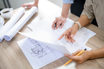 Concept of engineering consulting, Two female engineers is checking blueprint of building together