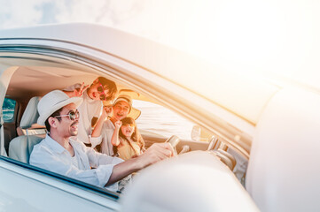 Portrait of family enjoying beach trip with their favorite car.