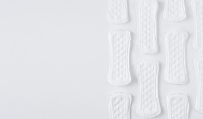 Pattern of feminine white sanitary pads with copyspace