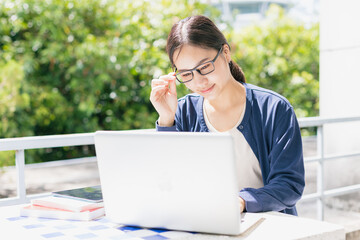 Asian teen girl with laptop computer for online education learning or programmer student in...