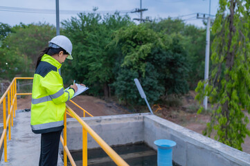 Fototapeta premium Environmental engineers work at wastewater treatment plants,Water supply engineering working at Water recycling plant for reuse,Check the amount of chlorine in the water to be within the criteria.