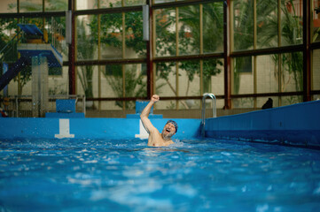 Excited senior man joy rejoicing in victory in swimming competitions