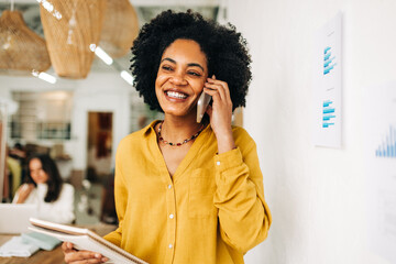 Business woman smiling while answering a call