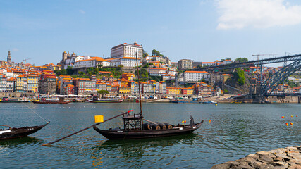 Obraz na płótnie Canvas Panoramic view of the old town of Porto and the Douro river with traditional boats with wine barrels, Portugal