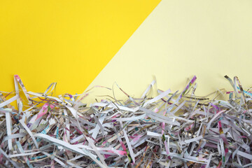 The shredded paper on light yellow background.