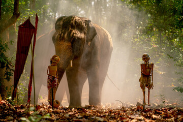 Asian elephant stand behide the puppet in forrest and mist with traditional flags.