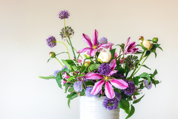 Flowers from a home garden in a vase on a white background.