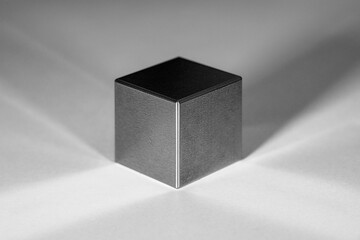 A tungsten cube with reflections and shadows against a white background - obrazy, fototapety, plakaty