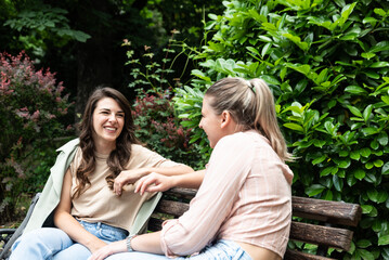 Friend comforting a stressed friend. Two woman young females talking in te park after divorce and abandon abusive husband. Support in stress and relationship marriage difficulties