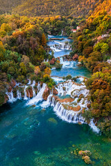 Krka, Croatia - Aerial panoramic view of the famous Krka Waterfalls in Krka National Park on a bright autumn morning with colorful autumn foliage