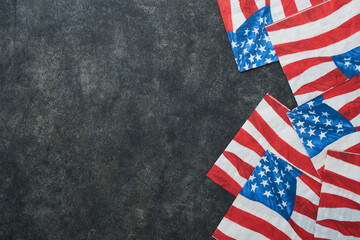 Fototapeta na wymiar 4th of July background. USA paper fans, Red, blue, white stars, balloons, gold confetti on gray dark concrete background. Happy Labor, Independence or Presidents Day. American flag colors. Top view.