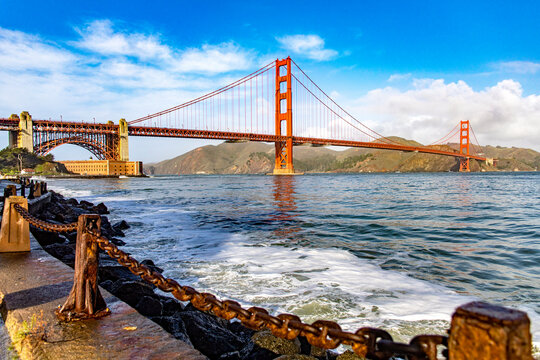 Golden Gate Bridge of San Francisco in the state of California, USA under a blue sky and ocean. Seen from the viewpoint of the Californian city's waterfront. American bridge concept.