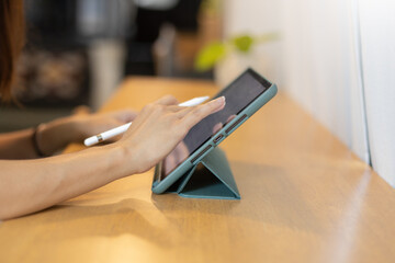 Female using digital tablet. woman working key touch display pad tablet.