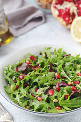 A plate with green rocket salad with pomegranate