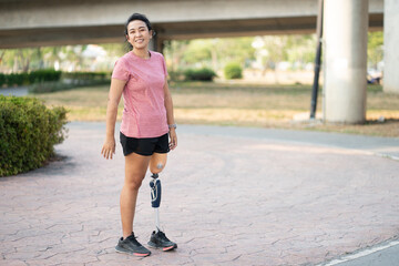 Portrait exercise woman with prosthetic leg in the park