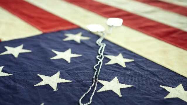 Dolly shot of vintage American flag with USA army, military dog tags. Concept fourth of july, 4th of July, Happy fourth of July USA independence day, celebration, Veteran's Day, Memorial Day, Holiday