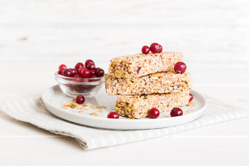 Various granola bars on table background. Cereal granola bars. Superfood breakfast bars with oats, nuts and berries, close up. Superfood concept
