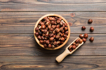 Wooden bowl full of hazelnuts on table background. Healthy eating concept. Super foods