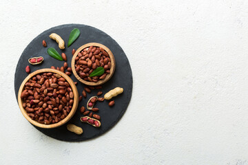 Fresh healthy peanuts in bowl on colored table background. Top view Healthy eating bertholletia concept. Super foods