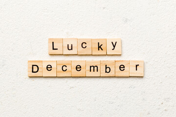 lucky december word written on wood block. lucky december text on table, concept