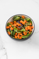  Green salad with sweet potatoes and sesame seeds. Vegan dish. Healthy eating. 