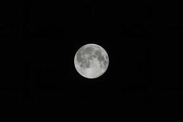 Full moon at night with black background.