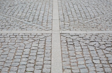 The square is lined with gray paving stone