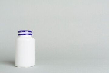 Plastic bottle for vitamins on color background