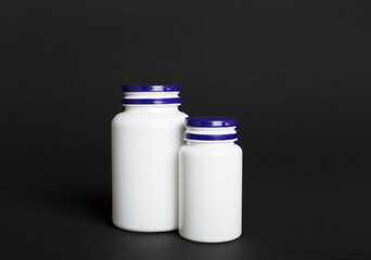 Plastic bottles for vitamins on color background