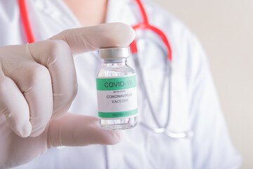 Doctors holding a bottle of covid-19 Coronavirus