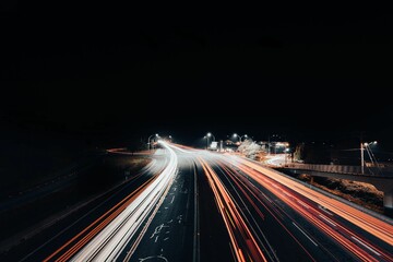 Long exposure shot of a traffic on a highway at night.